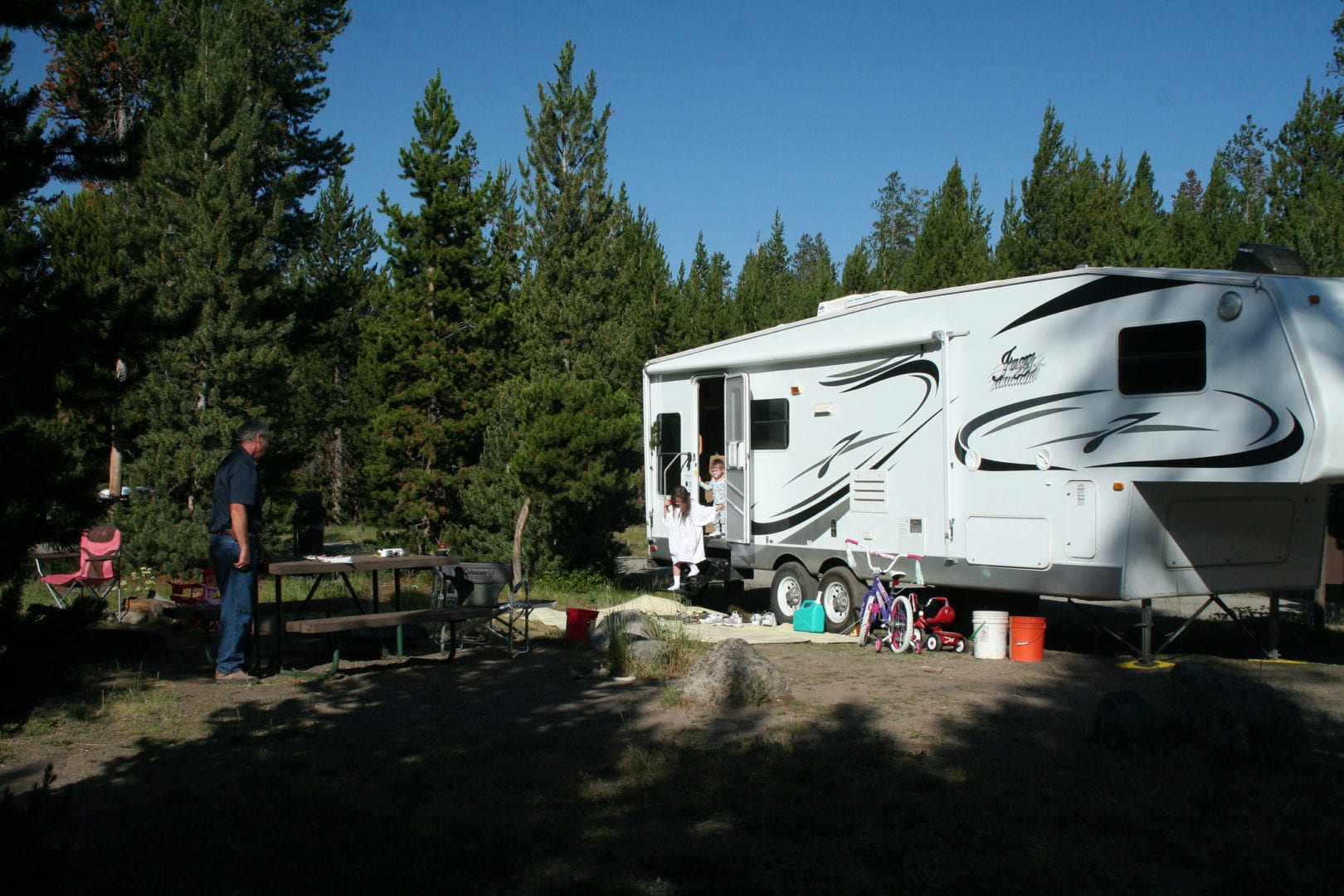 White RV Parked Near Indian Creek in Yellowstone National Park