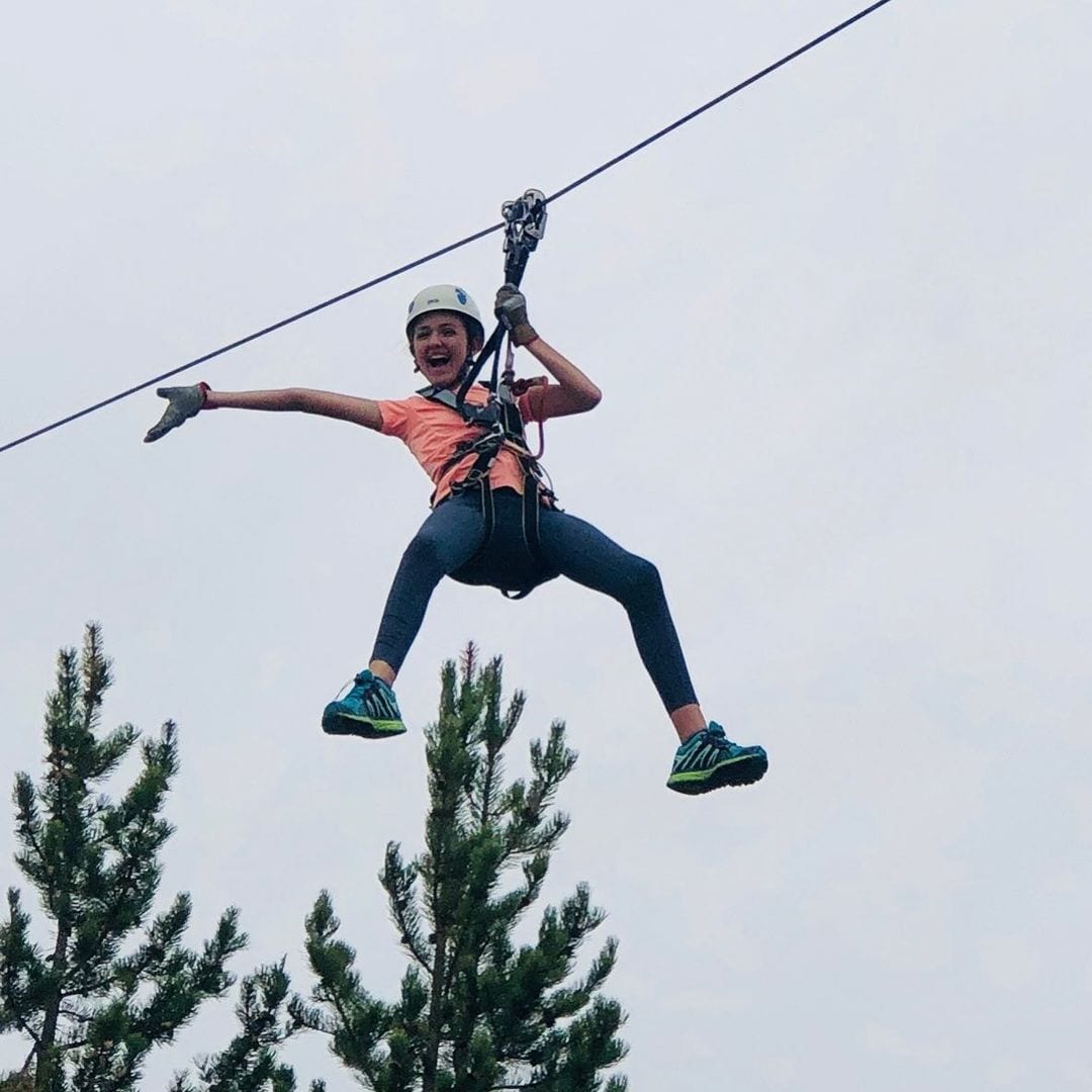 Smiling child on the Yellowstone Aerial Adventures Zipline